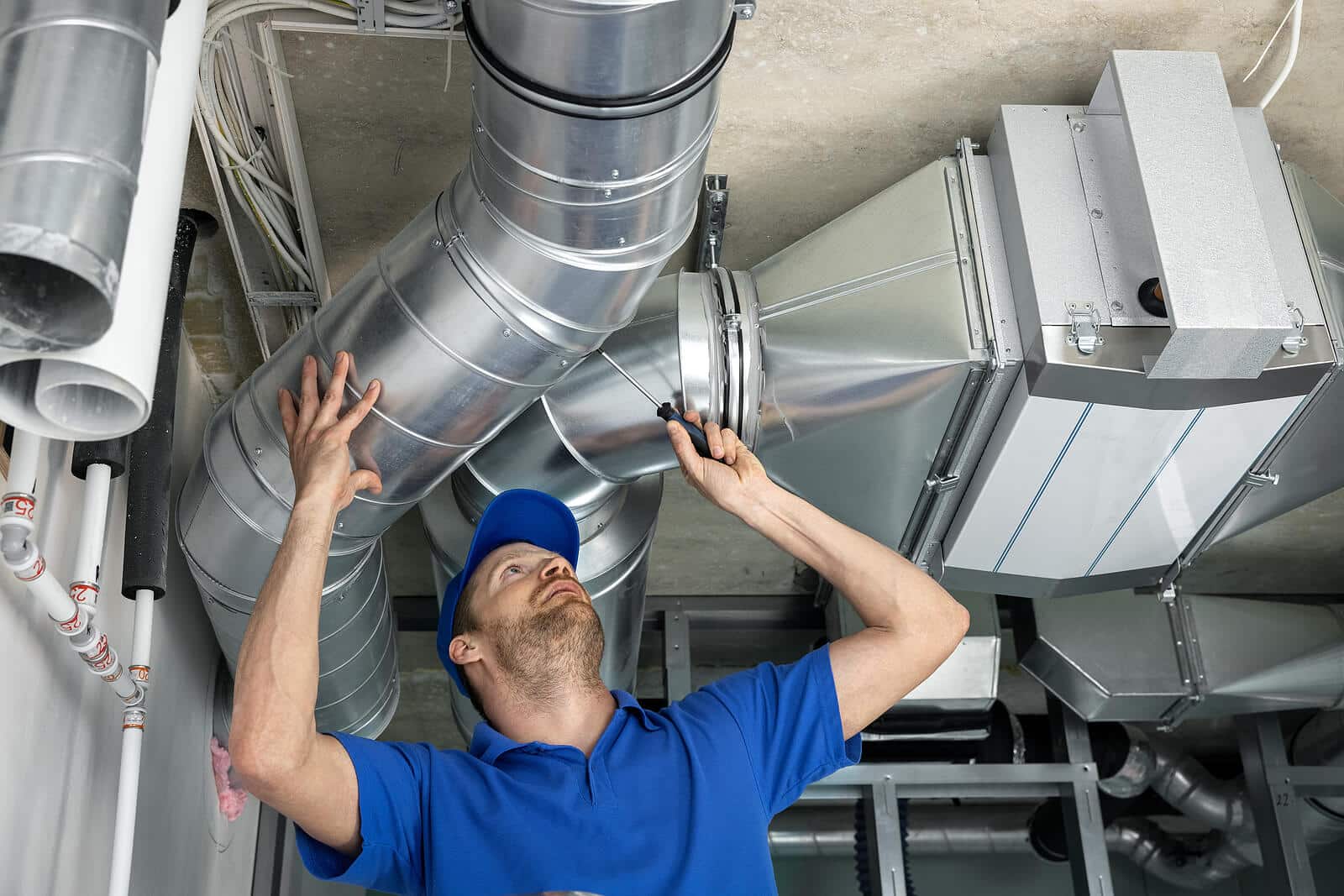 HVAC technician inspecting and repairing air ducts in Redondo Beach