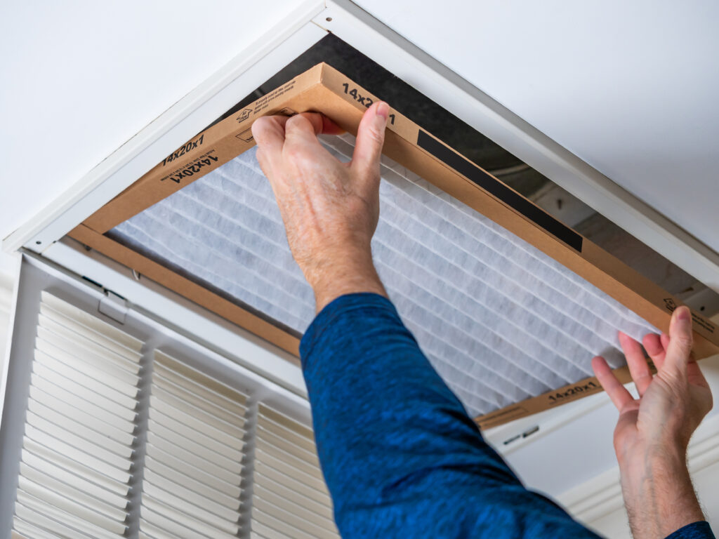 HVAC technician replacing a home air filter in Redondo Beach