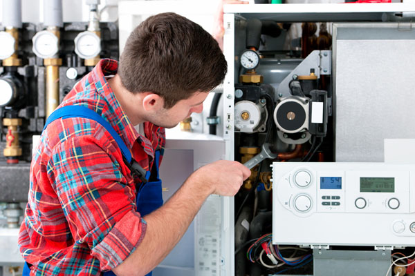 Heating technician repairing boiler controls in Redondo Beach