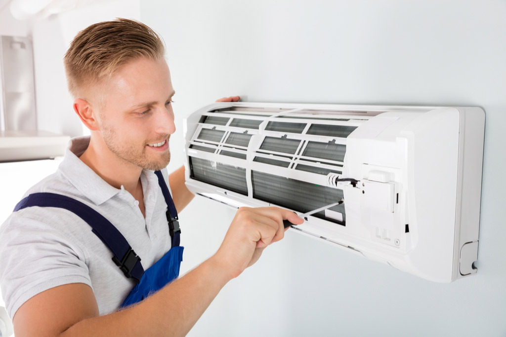 HVAC technician maintaining a ductless air conditioner in Redondo Beach