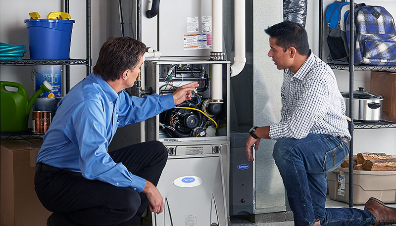 Technician evaluating a furnace for repair or replacement in Redondo Beach