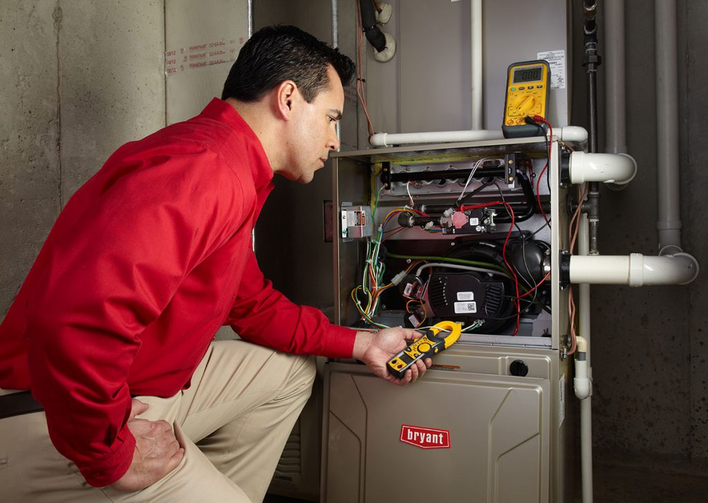 Heating technician diagnosing a furnace repair in Redondo Beach