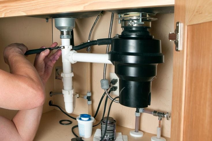 Plumber repairing a garbage disposal in Redondo Beach