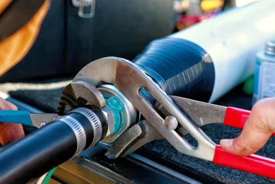 Technician repairing an industrial pipe connection in Redondo Beach