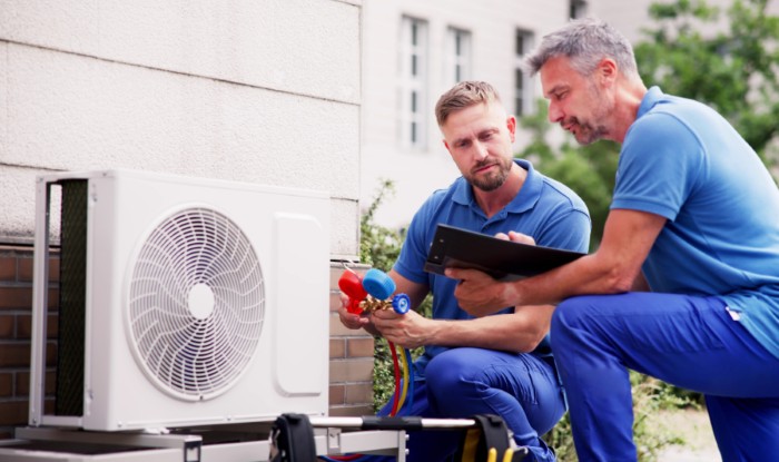 HVAC technicians installing an outdoor air conditioning unit in Redondo Beach