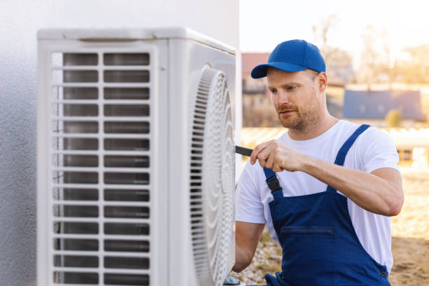 HVAC technician servicing an outdoor air conditioner in Redondo Beach