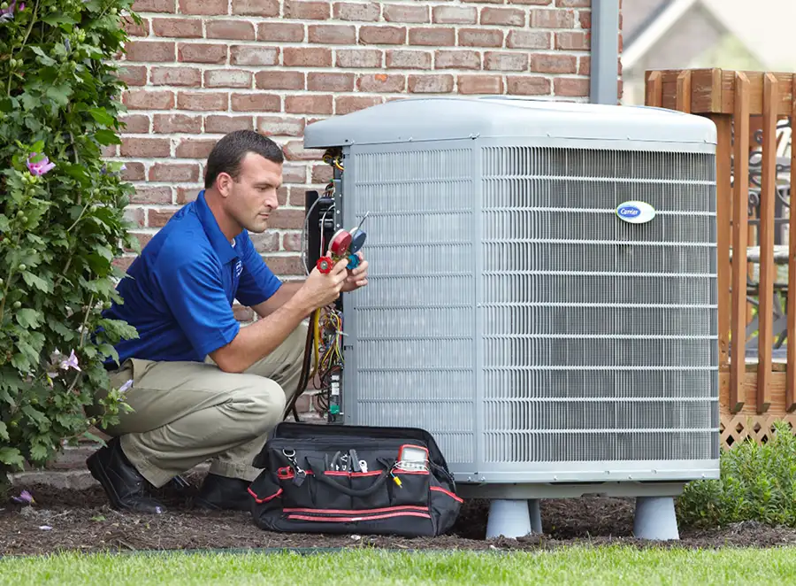 HVAC technician inspecting an outdoor AC unit in Redondo Beach